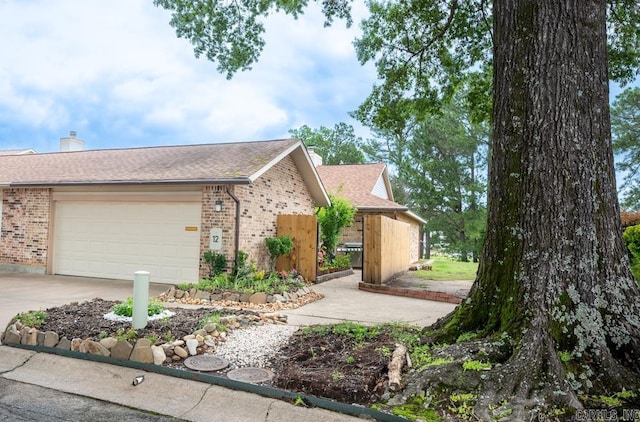 12 Wickford Ln, Little Rock, AR 72212 - ranch-style house with brick siding, a chimney, a garage, concrete driveway, and a shingled roof