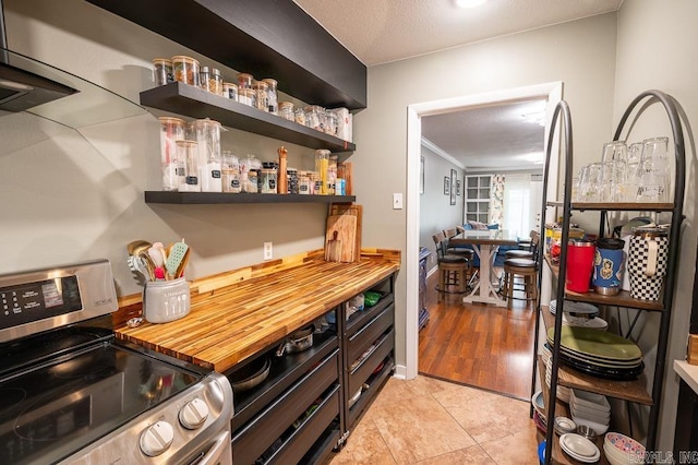 12 Wickford Ln, Little Rock, AR 72212 - bar area featuring electric stove, crown molding, baseboards, and light tile patterned floors