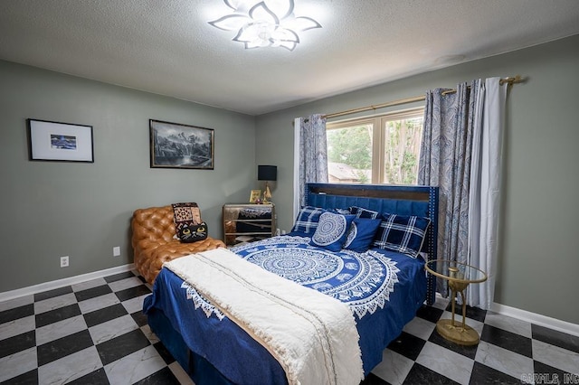 12 Wickford Ln, Little Rock, AR 72212 - bedroom featuring a textured ceiling, baseboards, and tile patterned floors