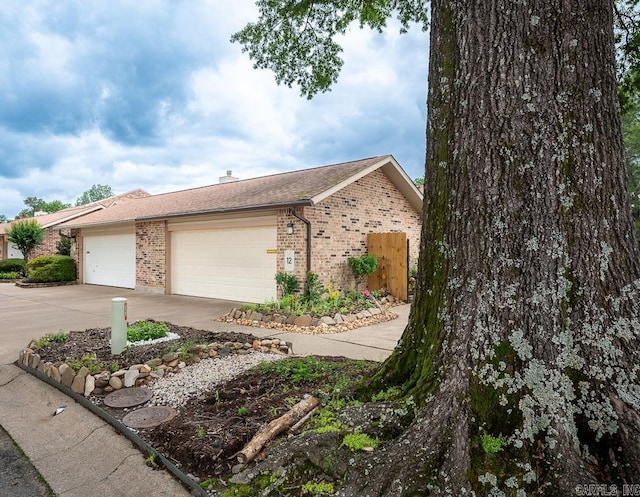 12 Wickford Ln, Little Rock, AR 72212 - view of front of home featuring brick siding, driveway, an attached garage, and roof with shingles