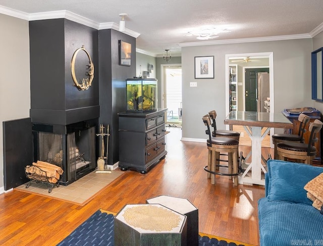 12 Wickford Ln, Little Rock, AR 72212 - living room with wood finished floors, ornamental molding, a fireplace, a ceiling fan, and baseboards