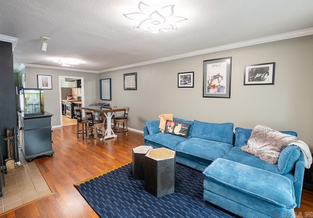 12 Wickford Ln, Little Rock, AR 72212 - living area with ornamental molding, wood finished floors, a textured ceiling, and baseboards