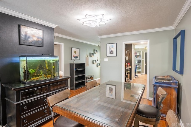 12 Wickford Ln, Little Rock, AR 72212 - dining room with crown molding, a textured ceiling, and wood finished floors