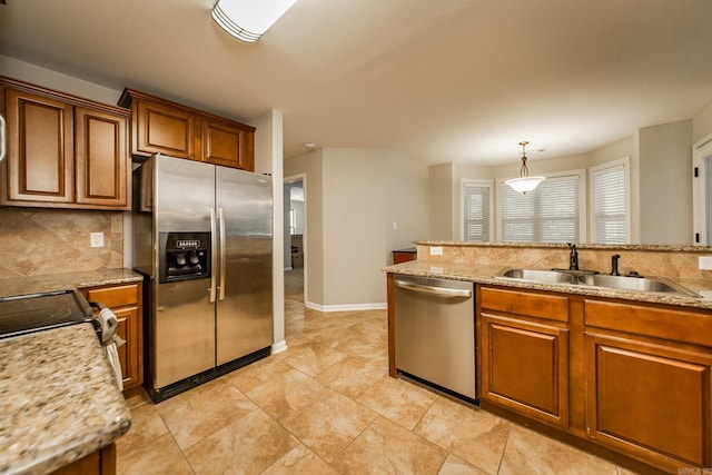 3305 Garden Club Dr, Bryant, AR 72022 - kitchen with stainless steel appliances, a sink, brown cabinets, and decorative backsplash