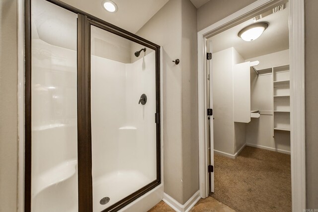 3305 Garden Club Dr, Bryant, AR 72022 - bathroom featuring a shower stall, baseboards, and a spacious closet