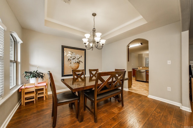 3305 Garden Club Dr, Bryant, AR 72022 - dining room with arched walkways, a tray ceiling, dark wood finished floors, crown molding, and a chandelier