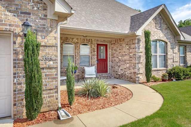3305 Garden Club Dr, Bryant, AR 72022 - view of exterior entry with roof with shingles, brick siding, and covered porch