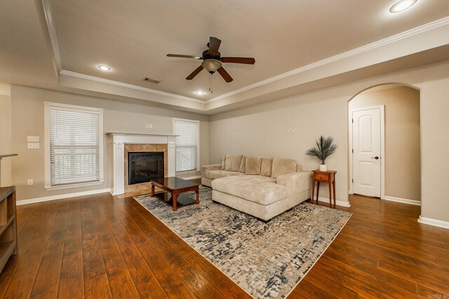 3305 Garden Club Dr, Bryant, AR 72022 - living room with a high end fireplace, a ceiling fan, a tray ceiling, dark wood-style flooring, and crown molding