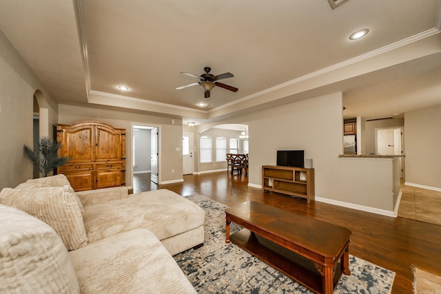 3305 Garden Club Dr, Bryant, AR 72022 - living room with arched walkways, a tray ceiling, wood finished floors, recessed lighting, and ornamental molding