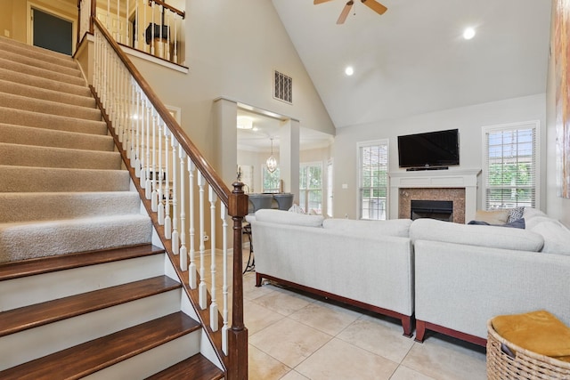12714 Meadows Edge Ln, Little Rock, AR 72211 - living room featuring stairway, healthy amount of natural light, light tile patterned floors, recessed lighting, and high vaulted ceiling