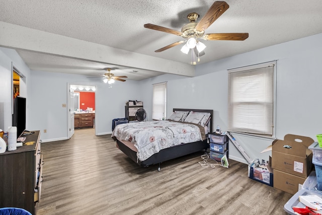 303 Pike Rd, Benton, AR 72019 - bedroom with wood finished floors, baseboards, a textured ceiling, ceiling fan, and ensuite bath