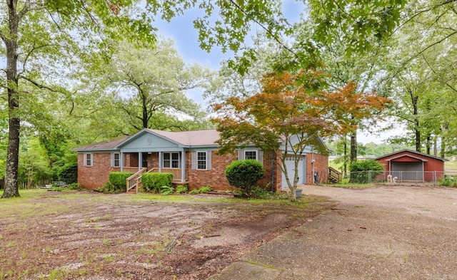 1257 Kimwood Dr, Benton, AR 72019 - ranch-style house featuring asphalt driveway, brick siding, a garage, and a porch