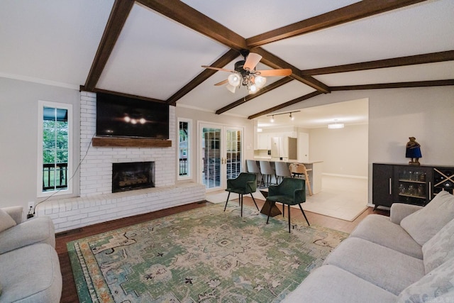 1257 Kimwood Dr, Benton, AR 72019 - living room featuring a ceiling fan, a fireplace, wood finished floors, and baseboards