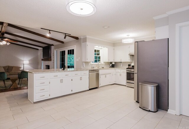 1257 Kimwood Dr, Benton, AR 72019 - kitchen with appliances with stainless steel finishes, a peninsula, white cabinets, a textured ceiling, and ceiling fan