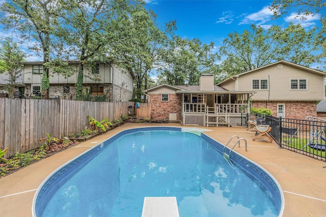 7713 Flintrock Rd, North Little Rock, AR 72116 - view of swimming pool featuring a fenced backyard, a deck, a patio area, and a diving board