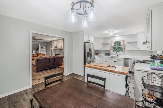 7713 Flintrock Rd, North Little Rock, AR 72116 - kitchen with open shelves, butcher block countertops, appliances with stainless steel finishes, a sink, and baseboards