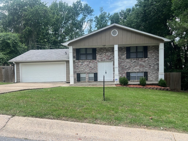 1206 E Twin Lakes Dr, Little Rock, AR 72204 - view of front of property with an attached garage, brick siding, driveway, and covered porch