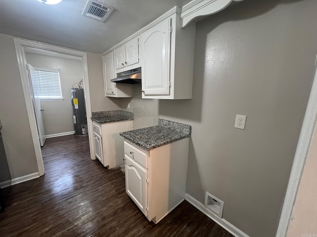 1206 E Twin Lakes Dr, Little Rock, AR 72204 - kitchen with water heater, dark wood finished floors, baseboards, white cabinets, and under cabinet range hood