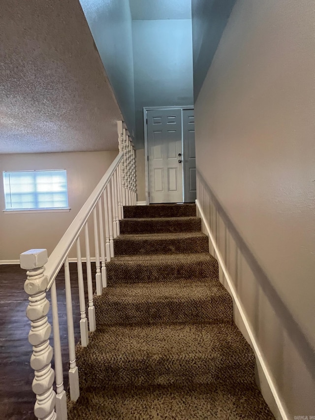 1206 E Twin Lakes Dr, Little Rock, AR 72204 - stairway with baseboards, a textured ceiling, and carpet flooring
