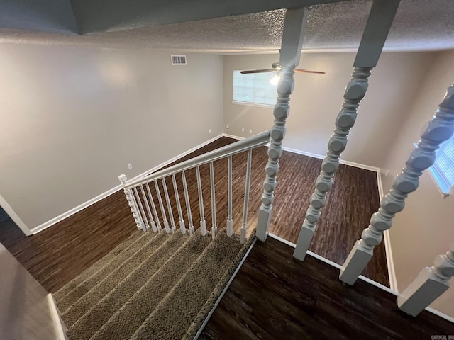 1206 E Twin Lakes Dr, Little Rock, AR 72204 - staircase featuring wood finished floors, baseboards, and a textured ceiling