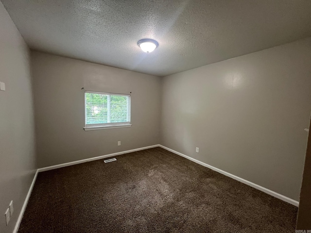 1206 E Twin Lakes Dr, Little Rock, AR 72204 - empty room with a textured ceiling, dark colored carpet, and baseboards