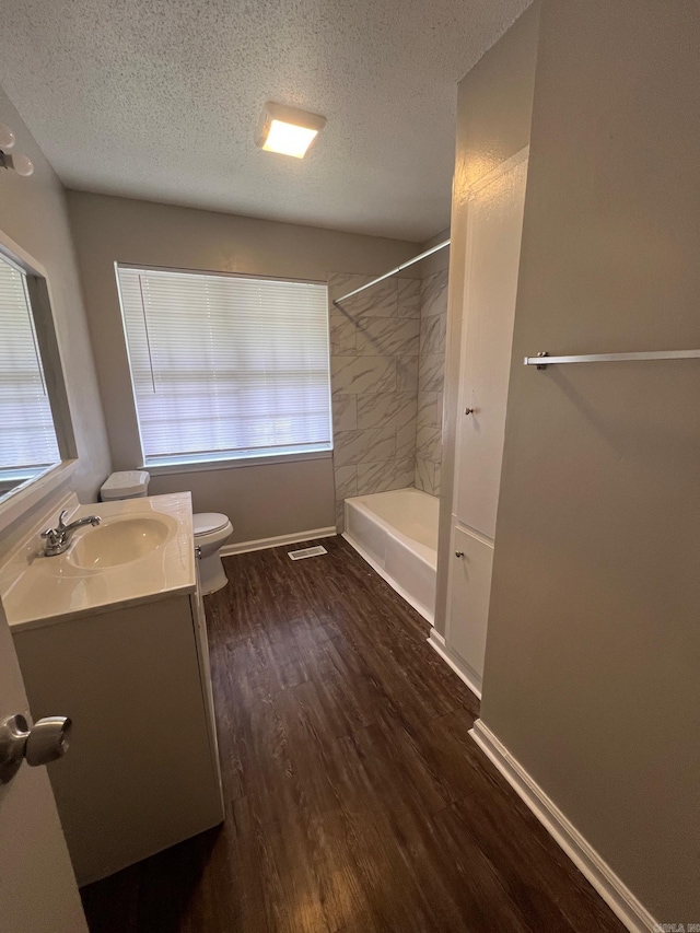 1206 E Twin Lakes Dr, Little Rock, AR 72204 - full bath with vanity, toilet, a textured ceiling, wood finished floors, and bathing tub / shower combination