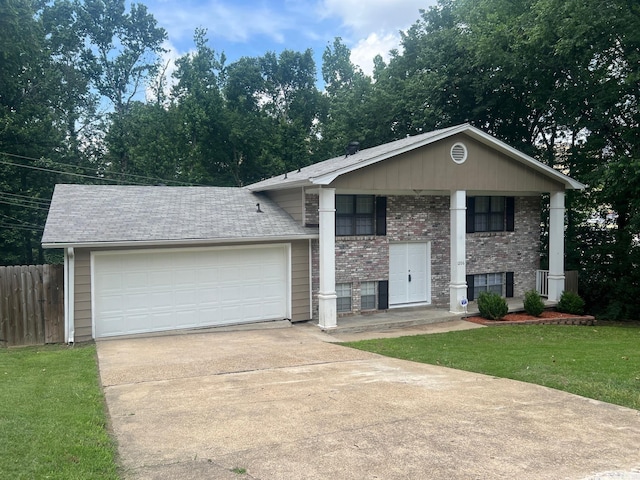 1206 E Twin Lakes Dr, Little Rock, AR 72204 - view of front of house featuring driveway, brick siding, an attached garage, and covered porch
