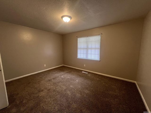 1206 E Twin Lakes Dr, Little Rock, AR 72204 - spare room with baseboards, a textured ceiling, and dark colored carpet