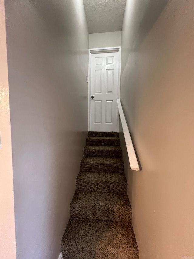 1206 E Twin Lakes Dr, Little Rock, AR 72204 - stairs with a textured ceiling