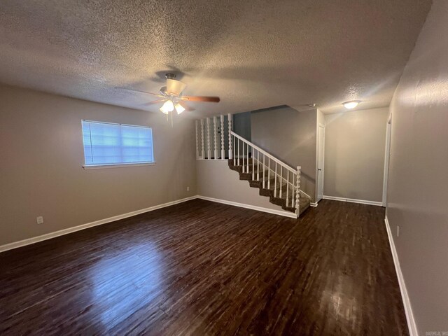 1206 E Twin Lakes Dr, Little Rock, AR 72204 - spare room featuring a textured ceiling, wood finished floors, a ceiling fan, baseboards, and stairway