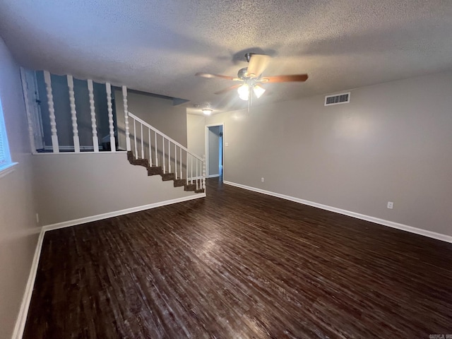 1206 E Twin Lakes Dr, Little Rock, AR 72204 - unfurnished living room with a ceiling fan, dark wood-type flooring, a textured ceiling, stairway, and baseboards