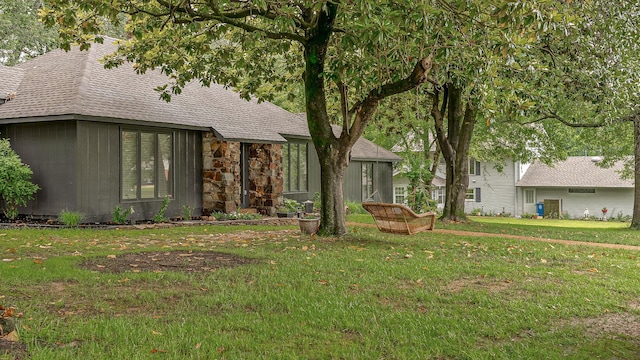 306 Cloverdale, Jonesboro, AR 72401 - view of front of house featuring a shingled roof, a front lawn, and stone siding