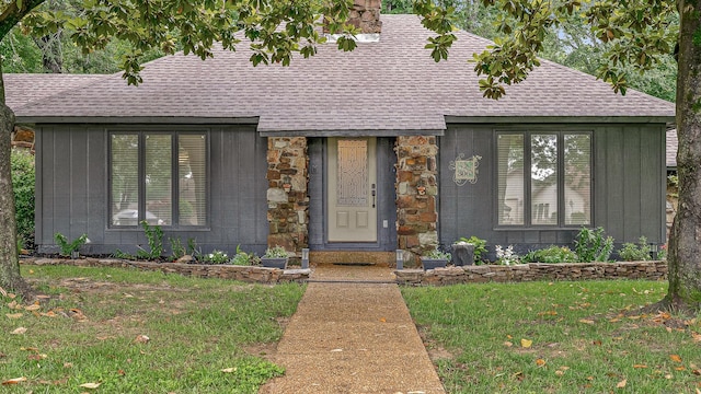 306 Cloverdale, Jonesboro, AR 72401 - view of front of home featuring roof with shingles, a front yard, and stone siding