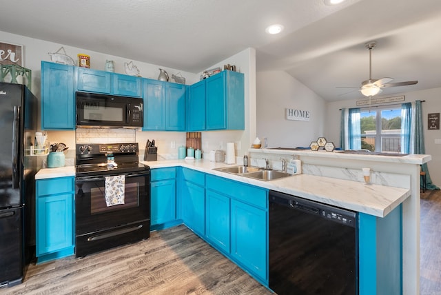 35 Summer Breeze Rd, Conway, AR 72032 - kitchen featuring black appliances, blue cabinets, a peninsula, light wood finished floors, and lofted ceiling