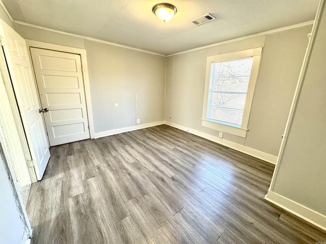 3112 W 16th St, Little Rock, AR 72204 - unfurnished bedroom featuring dark wood-type flooring, baseboards, and crown molding