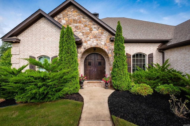 14 Cypress Valley Ct, Maumelle, AR 72113 - entrance to property featuring a shingled roof, stone siding, and brick siding