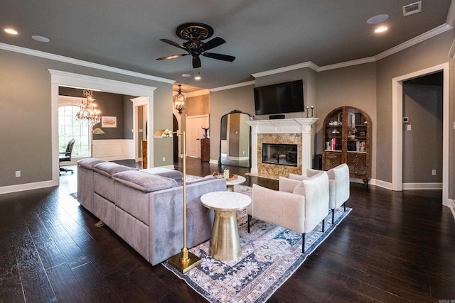 14 Cypress Valley Ct, Maumelle, AR 72113 - living area featuring ceiling fan, a high end fireplace, a chandelier, dark wood-style floors, and arched walkways