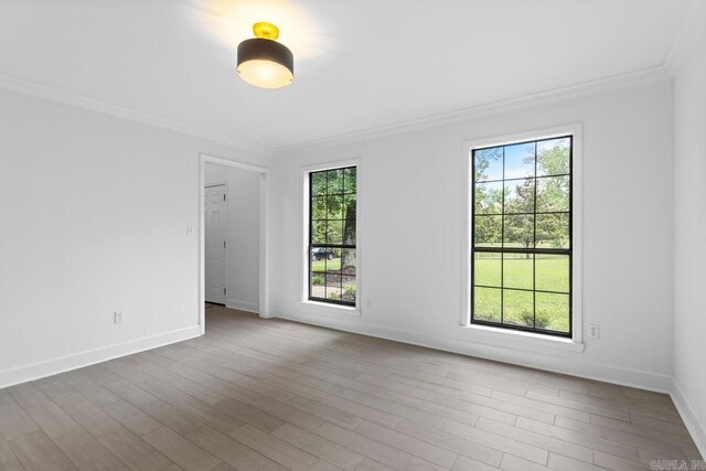 1208 Hilltop Rd, Alexander, AR 72022 - unfurnished room featuring crown molding, healthy amount of natural light, baseboards, and wood finished floors