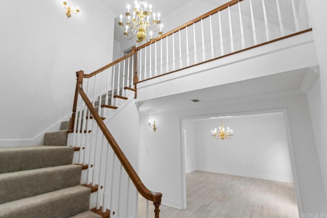 1208 Hilltop Rd, Alexander, AR 72022 - staircase with a chandelier, ornamental molding, wood finished floors, a towering ceiling, and baseboards