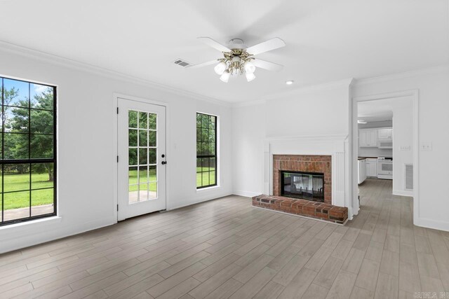 1208 Hilltop Rd, Alexander, AR 72022 - unfurnished living room featuring healthy amount of natural light, a ceiling fan, crown molding, light wood-style floors, and baseboards
