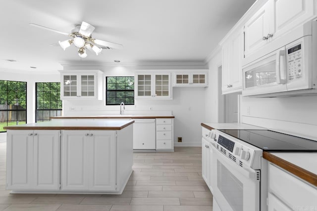 1208 Hilltop Rd, Alexander, AR 72022 - kitchen featuring white appliances, ornamental molding, a kitchen island, and white cabinetry
