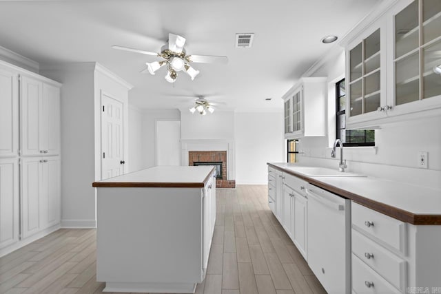 1208 Hilltop Rd, Alexander, AR 72022 - kitchen featuring dishwasher, a sink, a ceiling fan, a kitchen island, and light wood finished floors