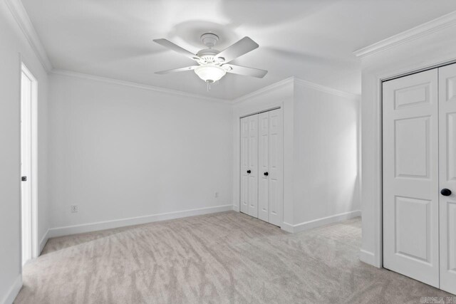 1208 Hilltop Rd, Alexander, AR 72022 - unfurnished bedroom with carpet flooring, ornamental molding, baseboards, ceiling fan, and multiple closets