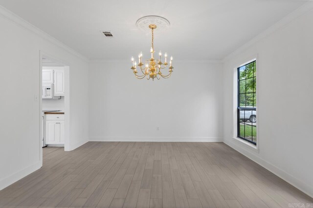 1208 Hilltop Rd, Alexander, AR 72022 - empty room with a chandelier, crown molding, wood finished floors, and baseboards