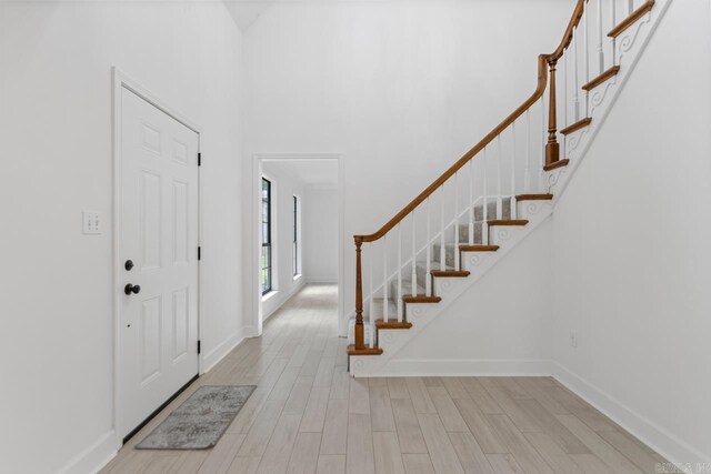1208 Hilltop Rd, Alexander, AR 72022 - entryway featuring wood finished floors, stairs, baseboards, and a towering ceiling