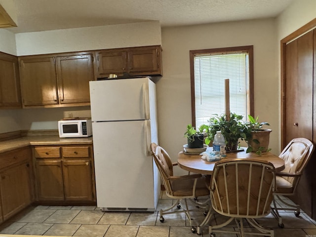 618 W Day St, Forrest City, AR 72335 - kitchen featuring white appliances, light countertops, and light tile patterned floors
