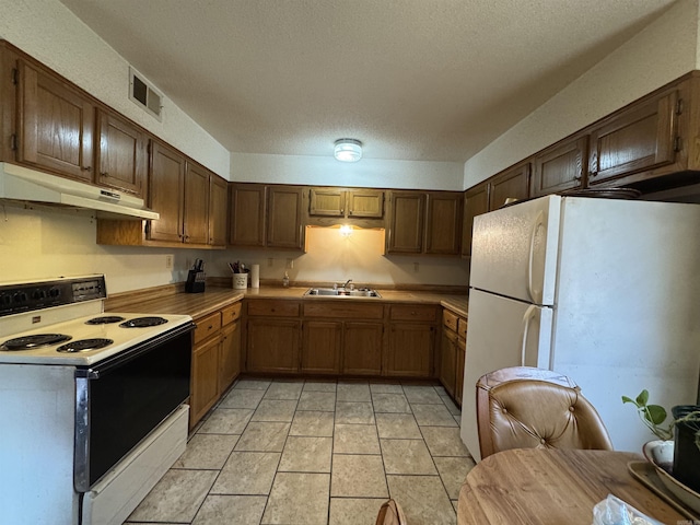 618 W Day St, Forrest City, AR 72335 - kitchen featuring white appliances, under cabinet range hood, a sink, light countertops, and a textured ceiling