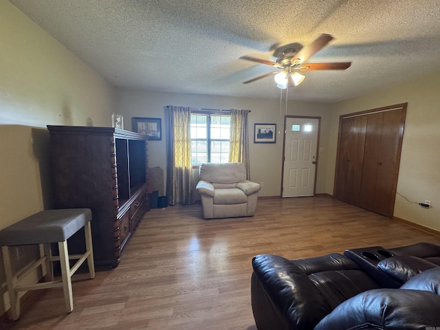 618 W Day St, Forrest City, AR 72335 - living room featuring ceiling fan, a textured ceiling, and wood finished floors