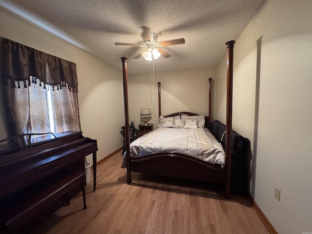 618 W Day St, Forrest City, AR 72335 - bedroom featuring wood finished floors, a textured ceiling, ceiling fan, and baseboards