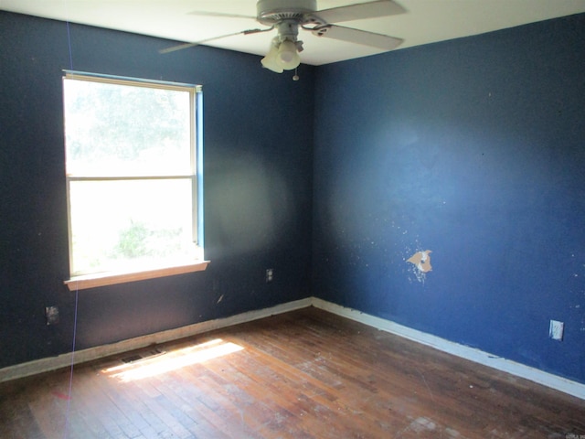 1001 Park St, North Little Rock, AR 72114 - unfurnished room featuring healthy amount of natural light, hardwood / wood-style floors, a ceiling fan, and baseboards